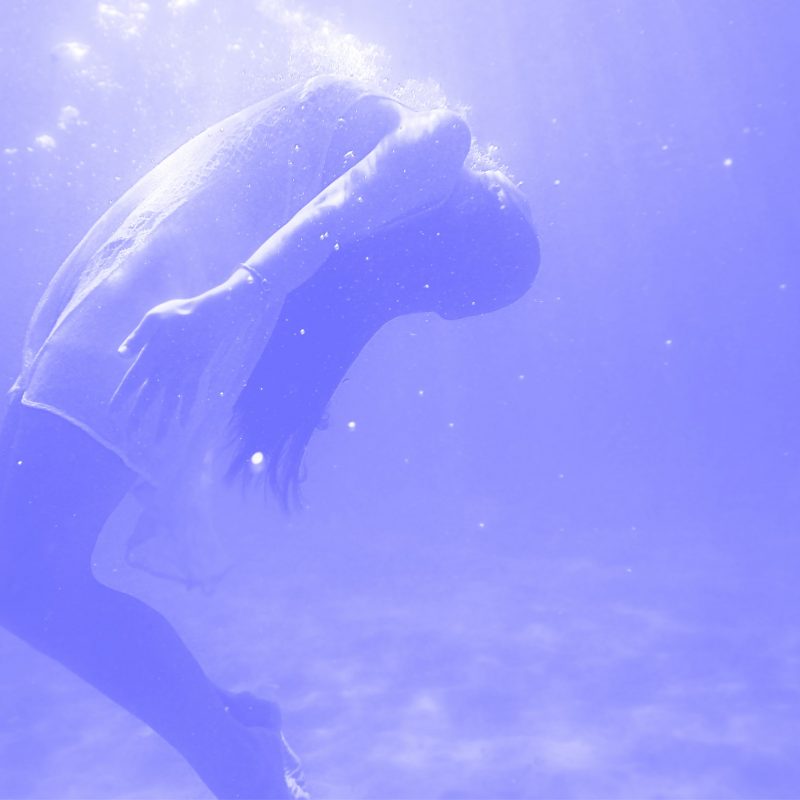 a person under water with their head in the air