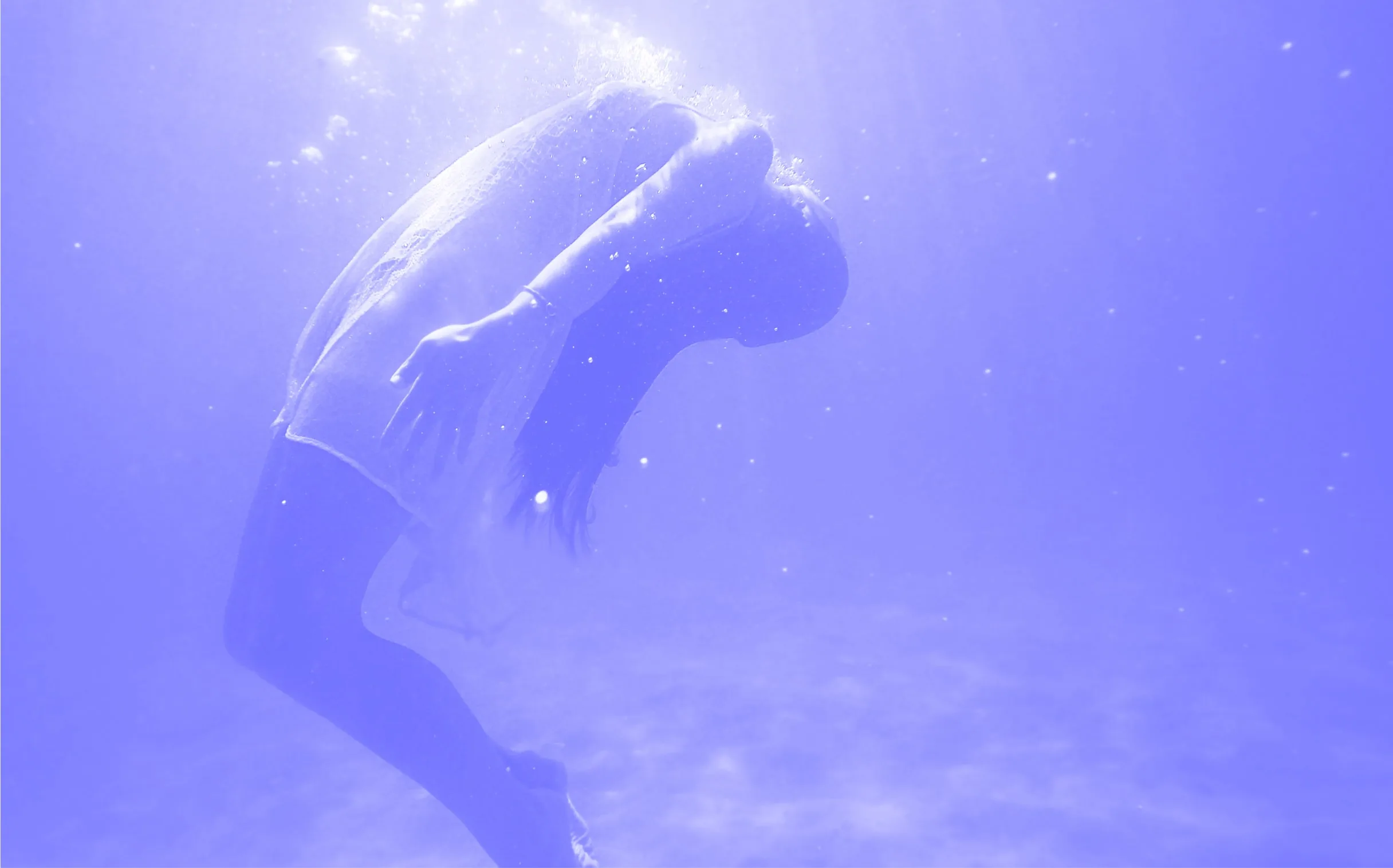 a person under water with their head in the air