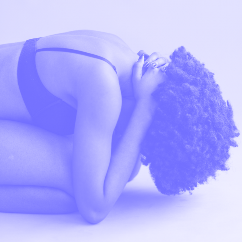 a woman in underwear with her head in her hands