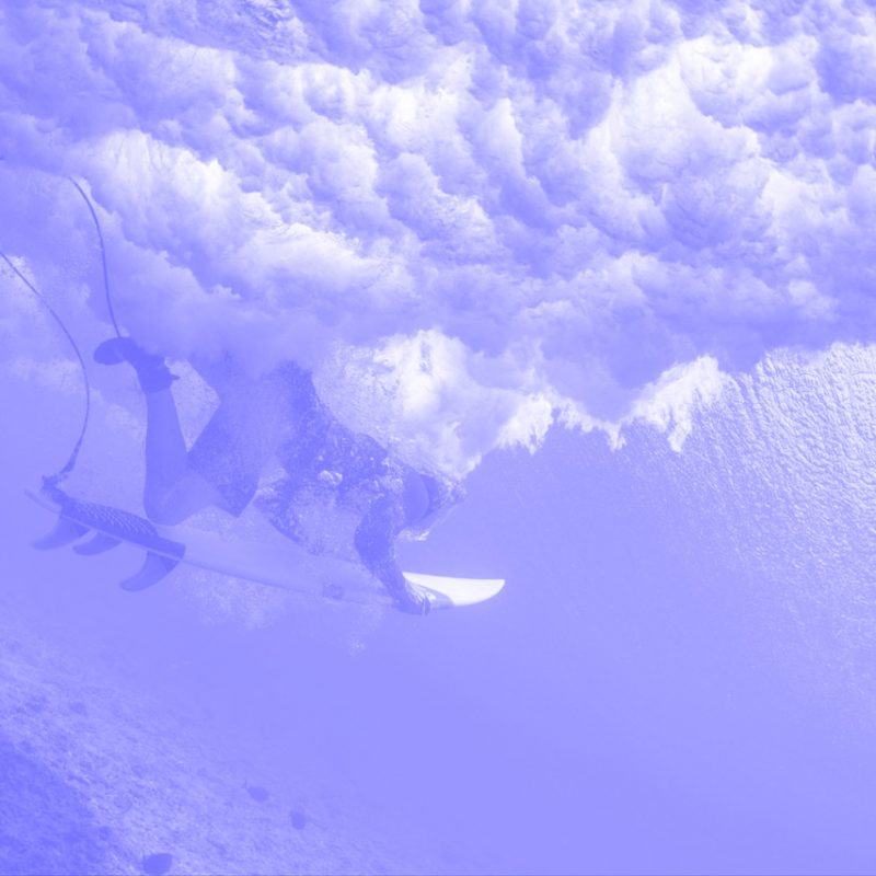 a person on a surfboard under a wave