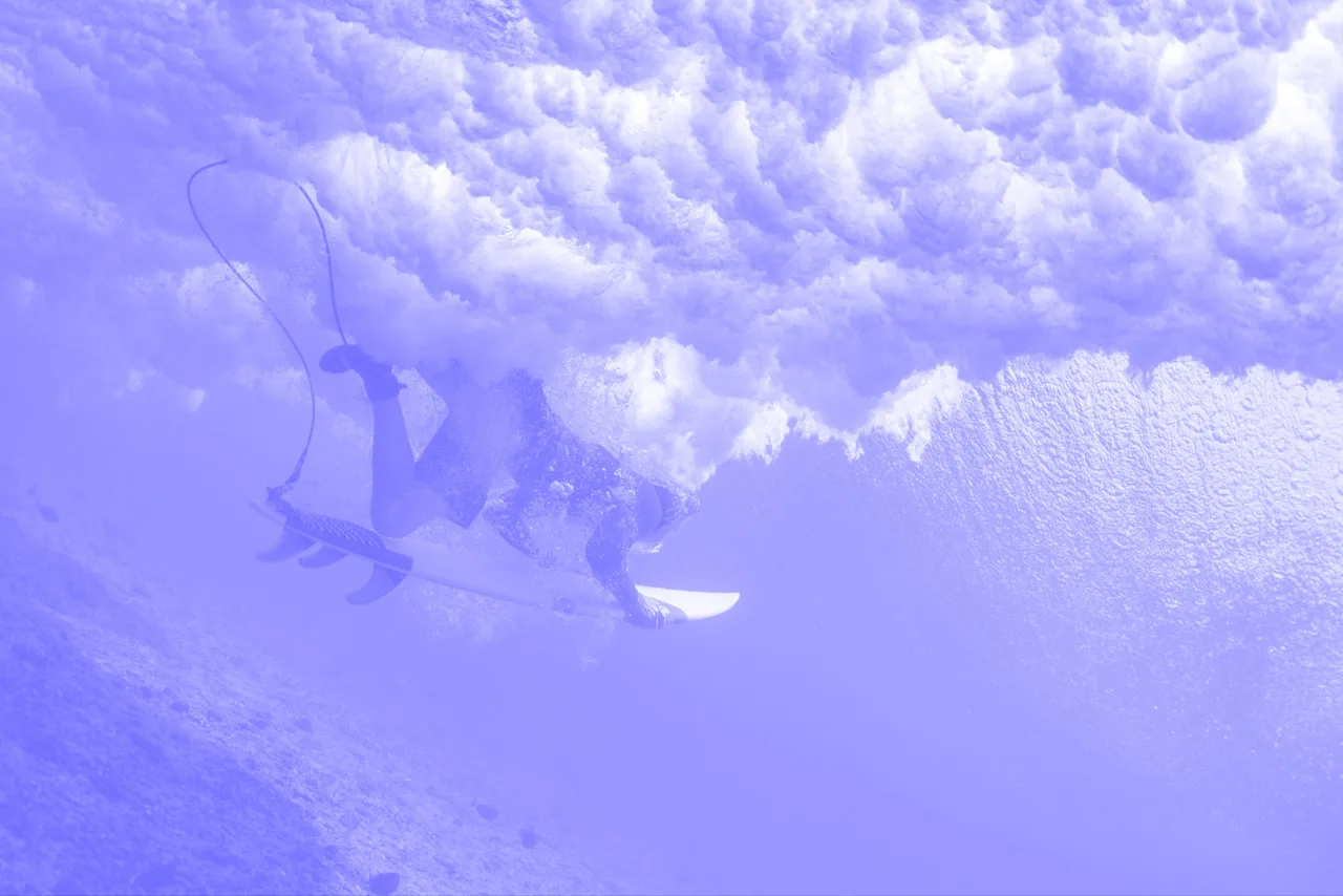 a person on a surfboard under a wave
